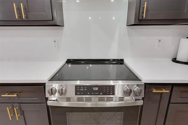 a stove top oven sitting inside of a kitchen