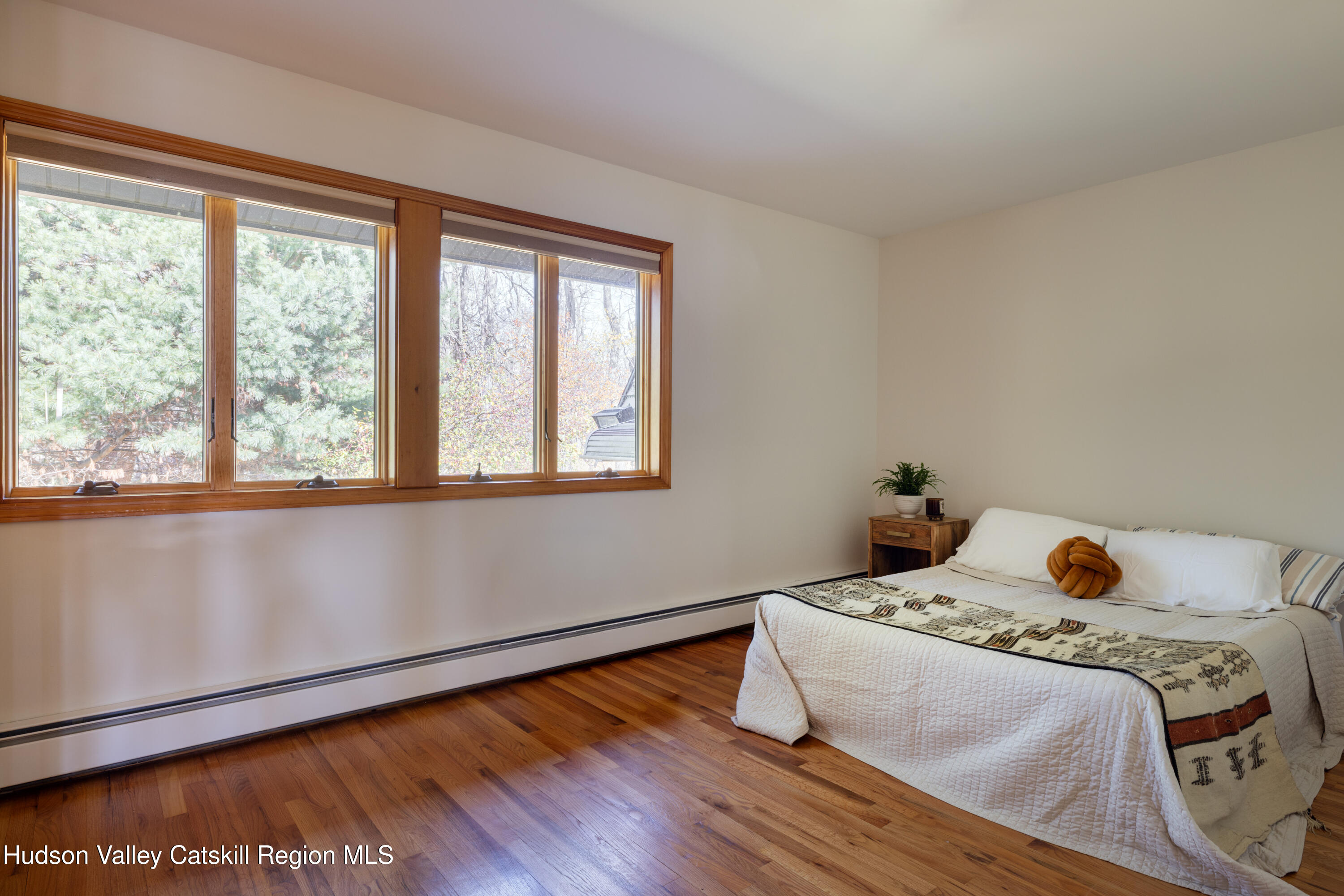 370 Forest Road Wallkill, NY 12589 - Photo 17 of 33 a bedroom with a bed and wooden floor