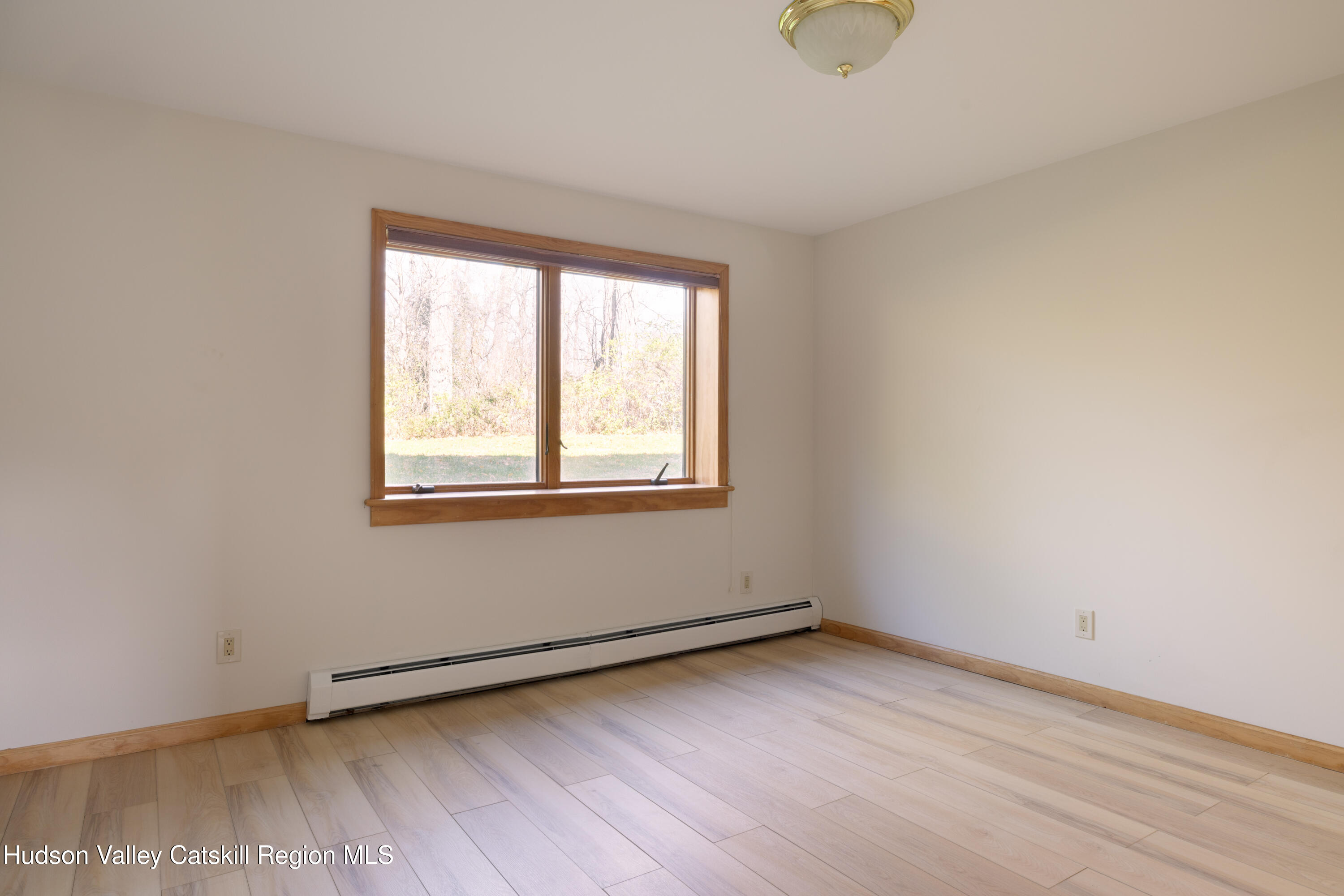 370 Forest Road Wallkill, NY 12589 - Photo 20 of 33 an empty room with wooden floor and windows