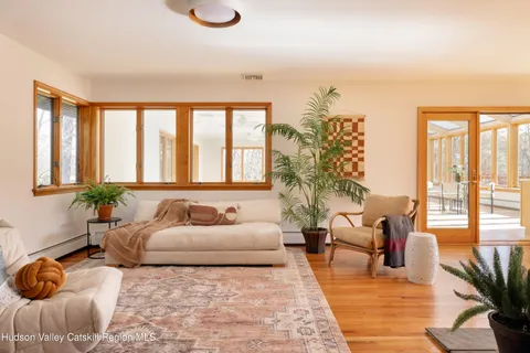 a living room with furniture and floor to ceiling windows