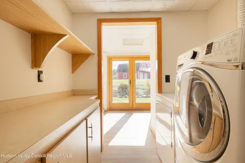 a view of a hallway with washer and dryer