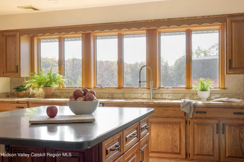 a kitchen with a sink and a large window