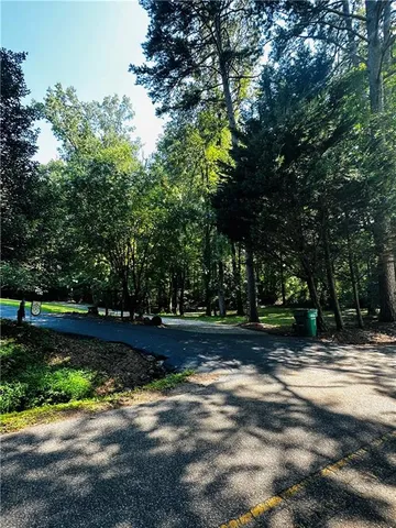 a large kitchen with stainless steel appliances a large counter top a stove and a refrigerator