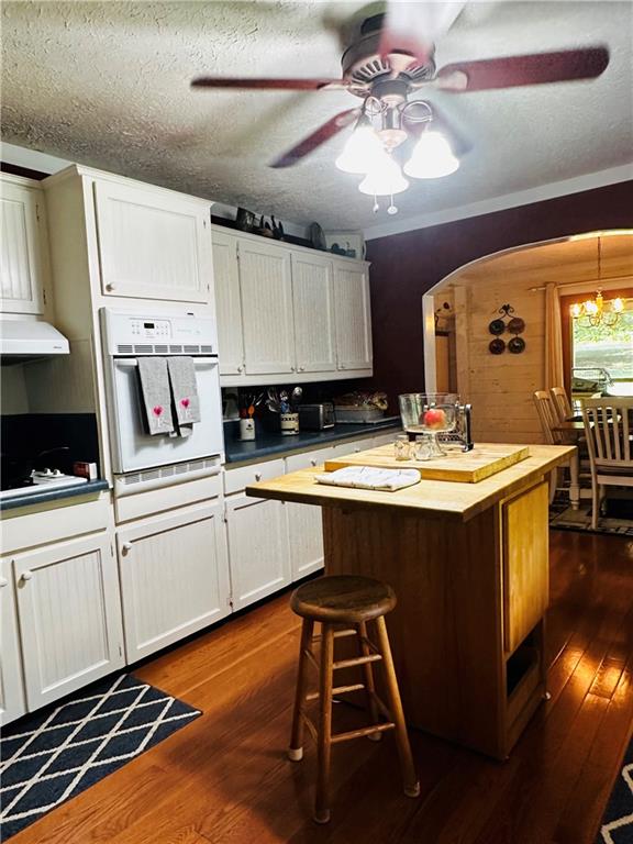 368 Dixon Road Demorest, GA 30535 - Photo 33 of 67 a kitchen with stainless steel appliances kitchen island granite countertop a sink dishwasher and white cabinets with wooden floor