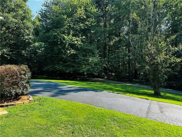a view of a barn in the middle of a yard