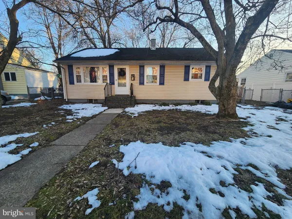 a view of a house with a yard covered in snow