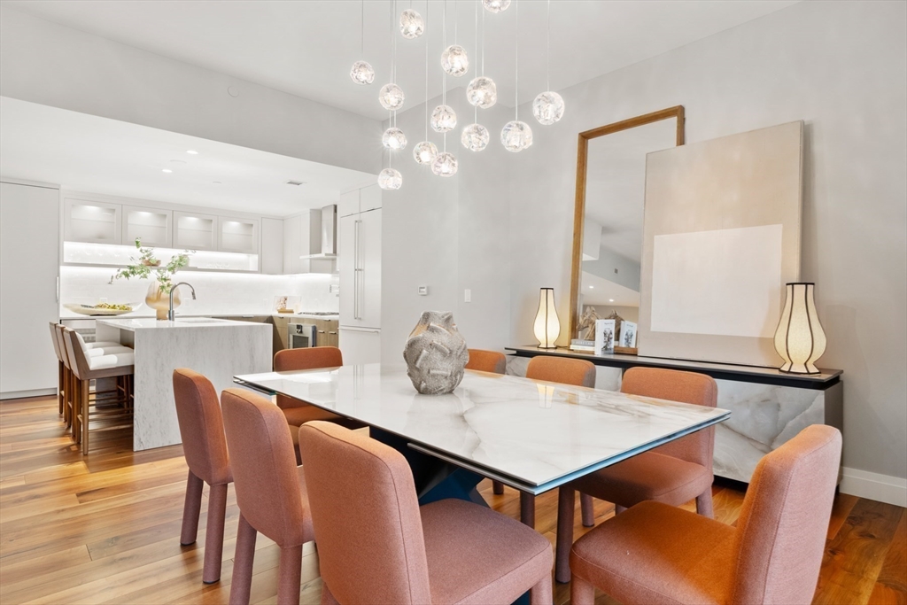 300 Pier 4 Blvd., Unit 7G Boston, MA 02210 - Photo 11 of 39 a view of a dining room with furniture and wooden floor