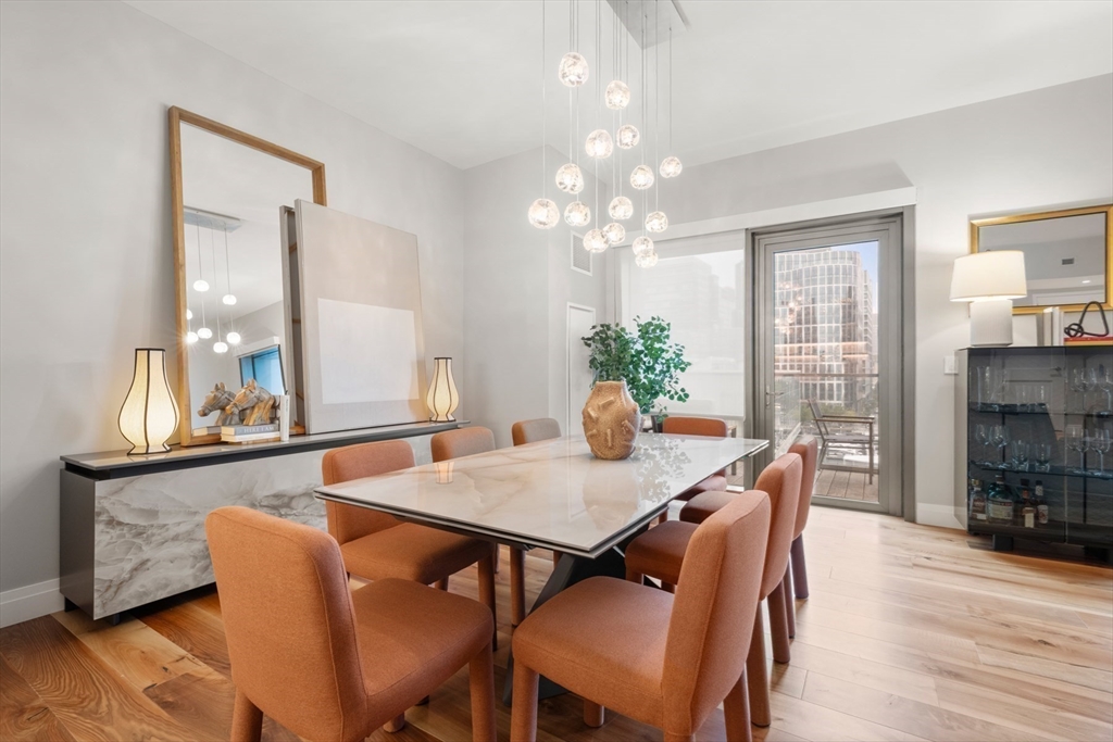 300 Pier 4 Blvd., Unit 7G Boston, MA 02210 - Photo 12 of 39 a view of a dining room with furniture window and wooden floor