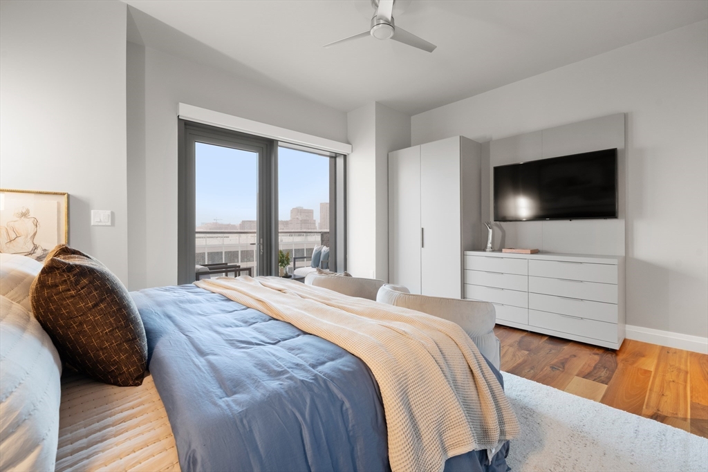 300 Pier 4 Blvd., Unit 7G Boston, MA 02210 - Photo 16 of 39 a bedroom with a bed tv and window
