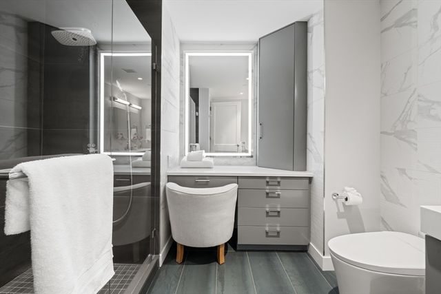 a bathroom with a sink a toilet and a mirror