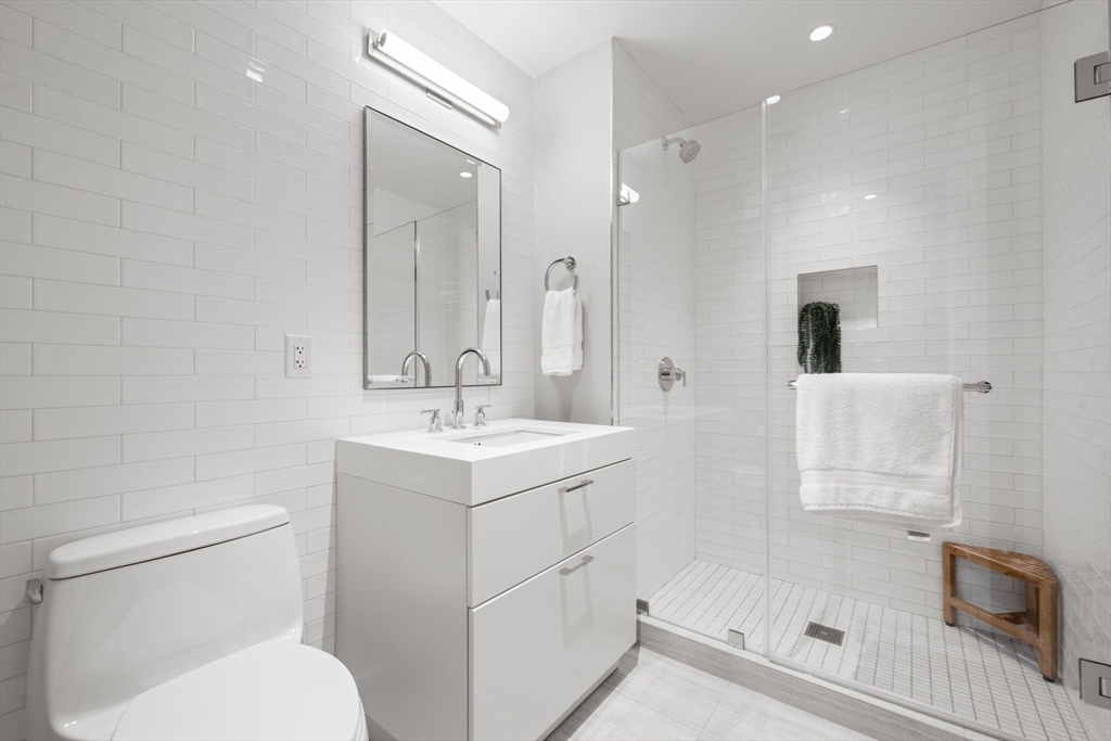 300 Pier 4 Blvd., Unit 7G Boston, MA 02210 - Photo 22 of 39 a bathroom with a sink a toilet and shower