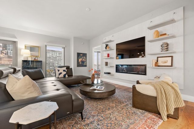 a living room with fireplace furniture and a flat screen tv