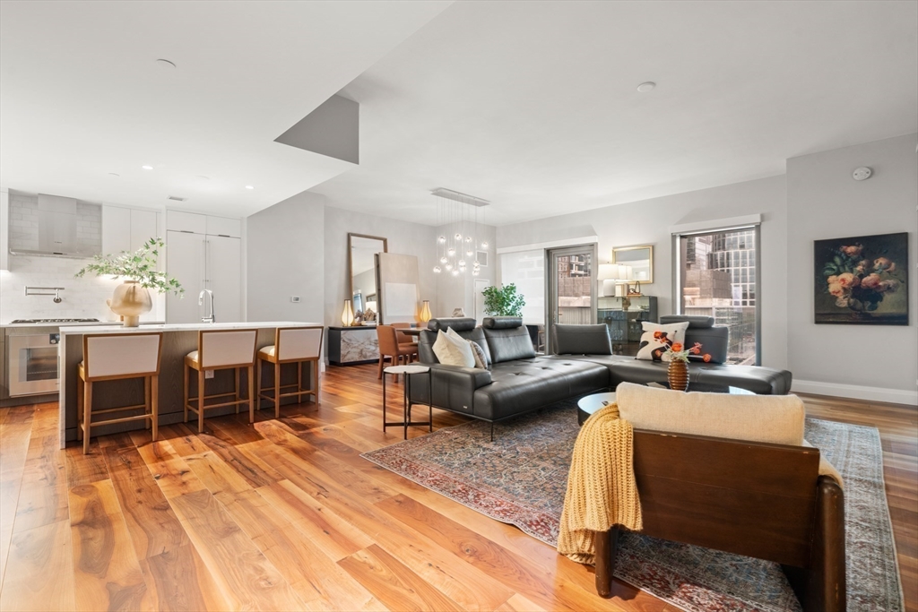 300 Pier 4 Blvd., Unit 7G Boston, MA 02210 - Photo 6 of 39 a living room with furniture kitchen view and a wooden floor