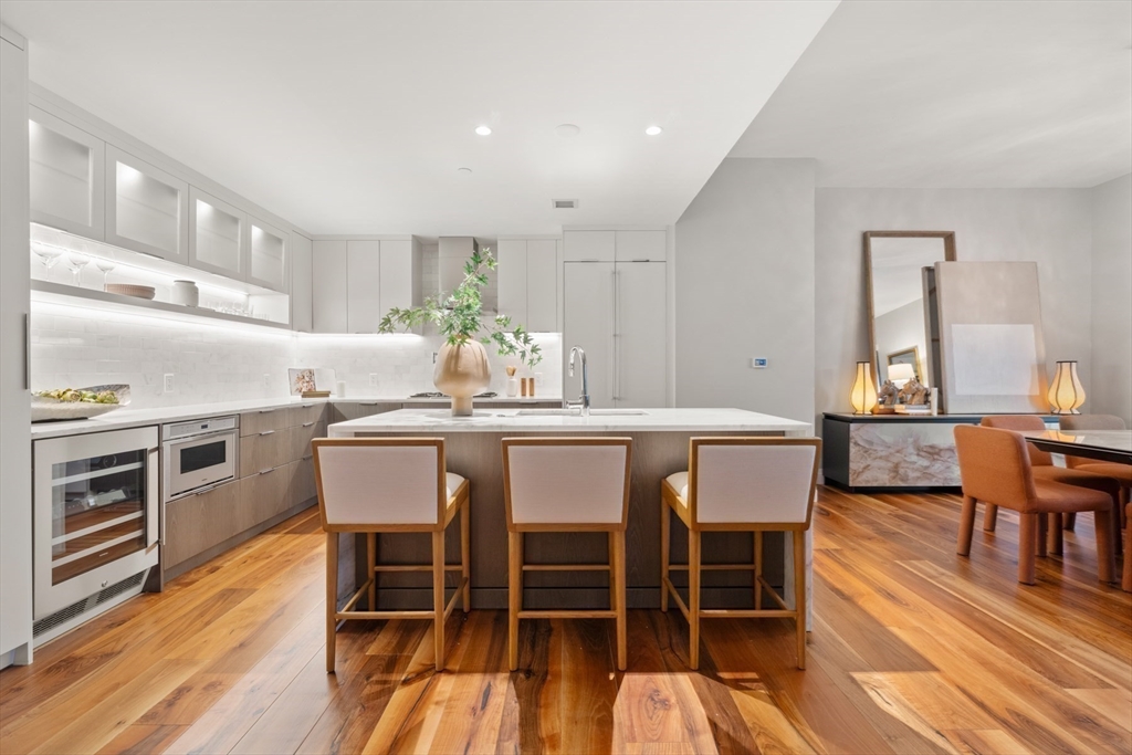 300 Pier 4 Blvd., Unit 7G Boston, MA 02210 - Photo 7 of 39 a dining room with furniture and wooden floor