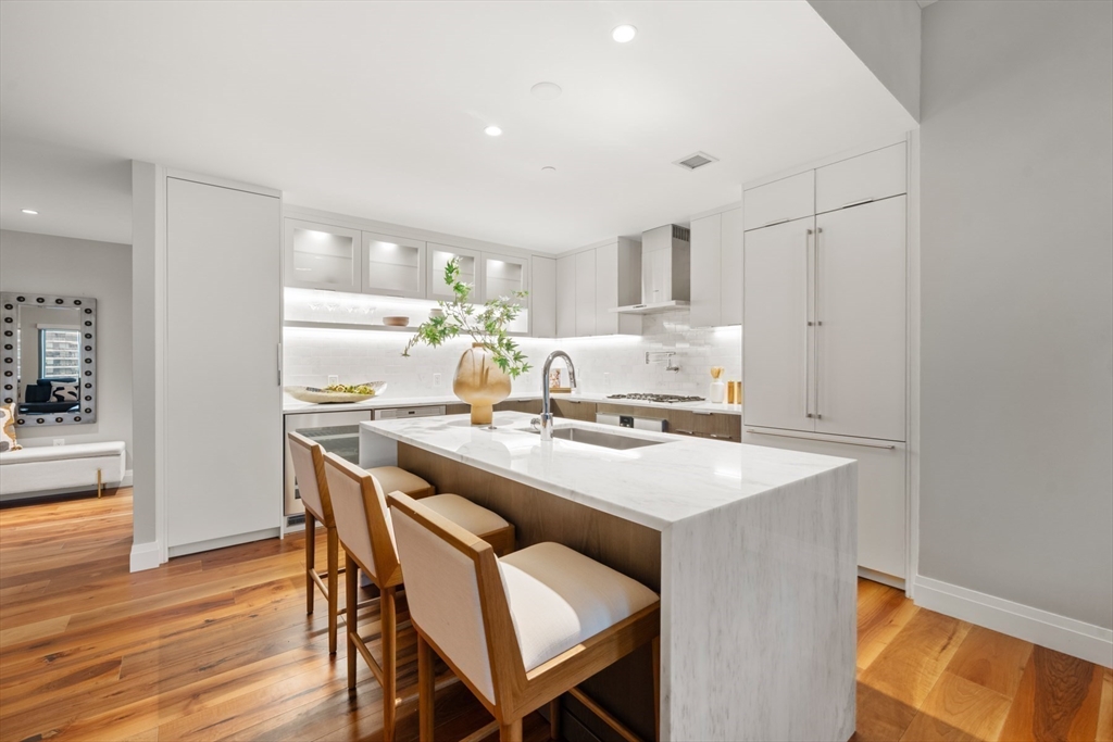 300 Pier 4 Blvd., Unit 7G Boston, MA 02210 - Photo 8 of 39 a kitchen with a table and chairs in it