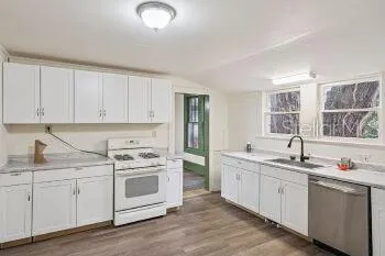 a kitchen with a sink stove and cabinets