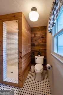 a bathroom with a shower and a sink