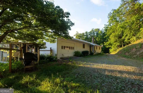 a backyard of a house with table and chairs