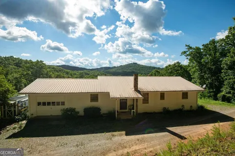 a backyard of a house with lots of green space and trees