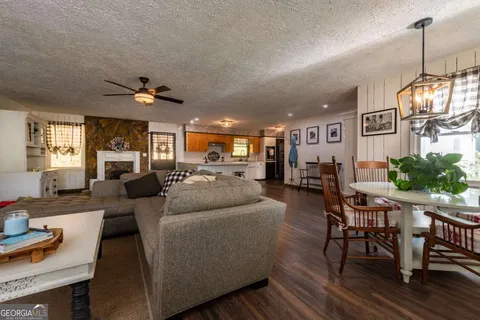 a living room with furniture and a chandelier