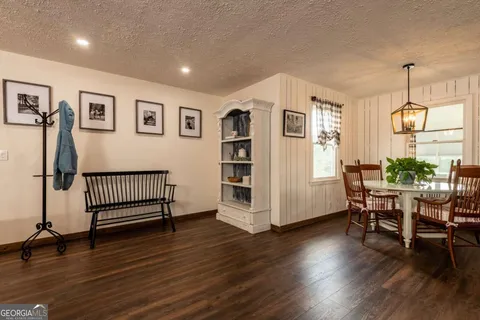 a view of a livingroom with furniture and hardwood floor