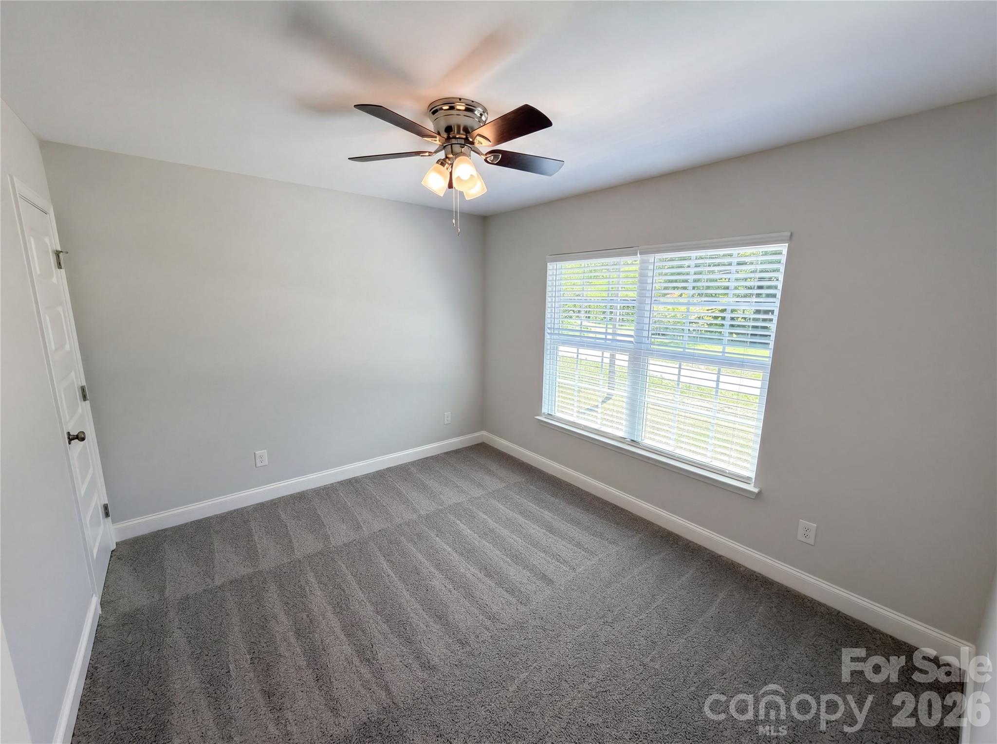 4918 Griffith Road Monroe, NC 28112 - Photo 11 of 17 an empty room with windows and fan
