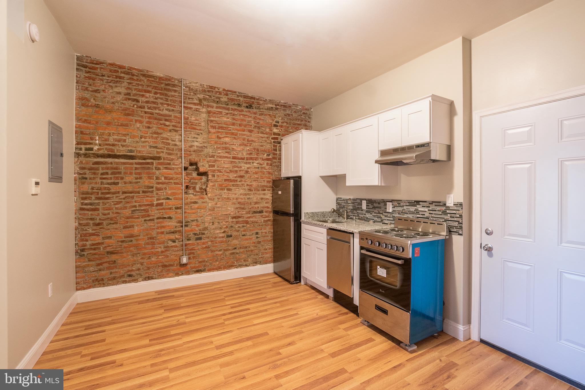 1126 East Passyunk Avenue, Unit 3 Philadelphia, PA 19147 - Photo 2 of 9 a kitchen with stainless steel appliances granite countertop a stove and a refrigerator