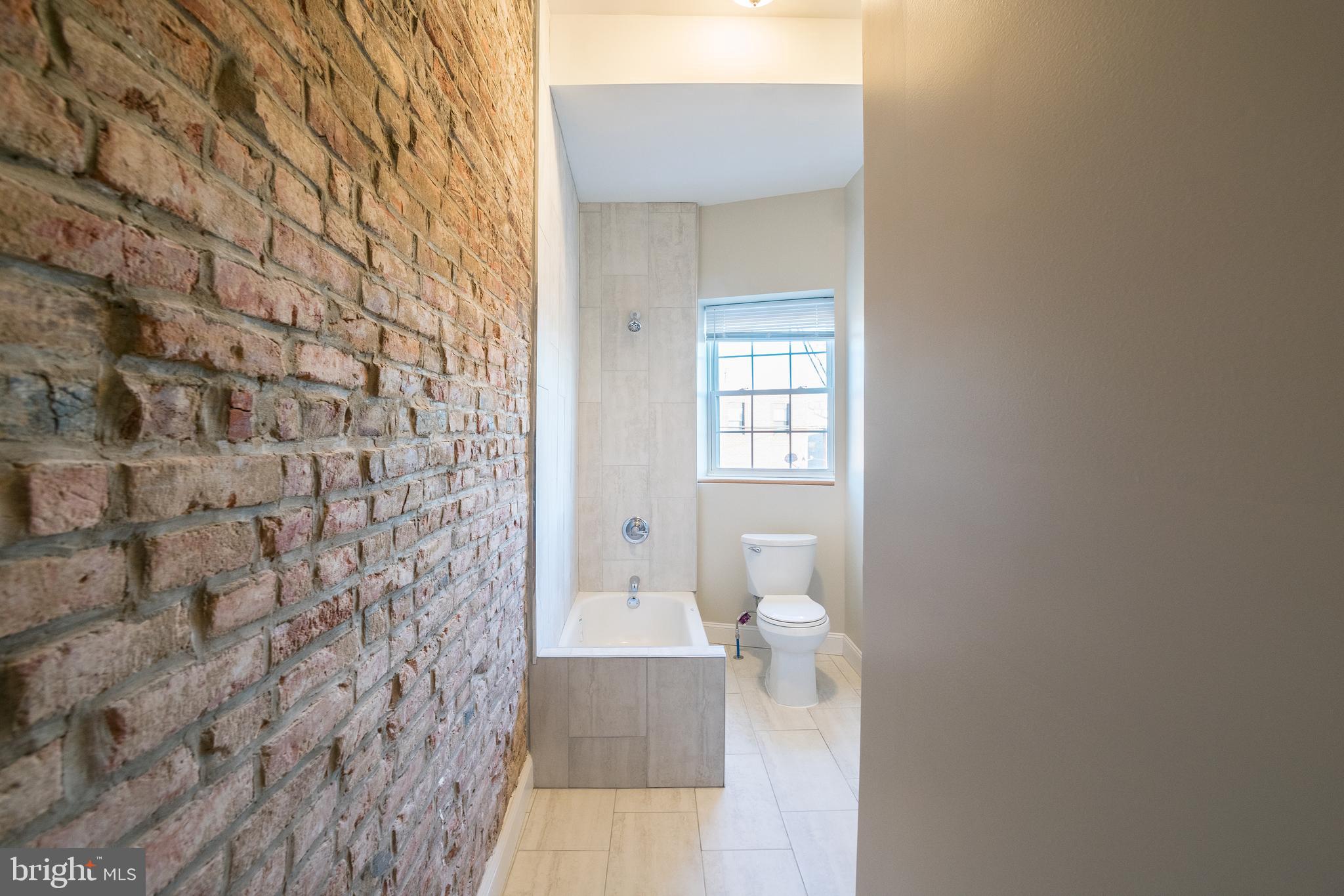1126 East Passyunk Avenue, Unit 3 Philadelphia, PA 19147 - Photo 7 of 9 a bathroom with a toilet and a shower