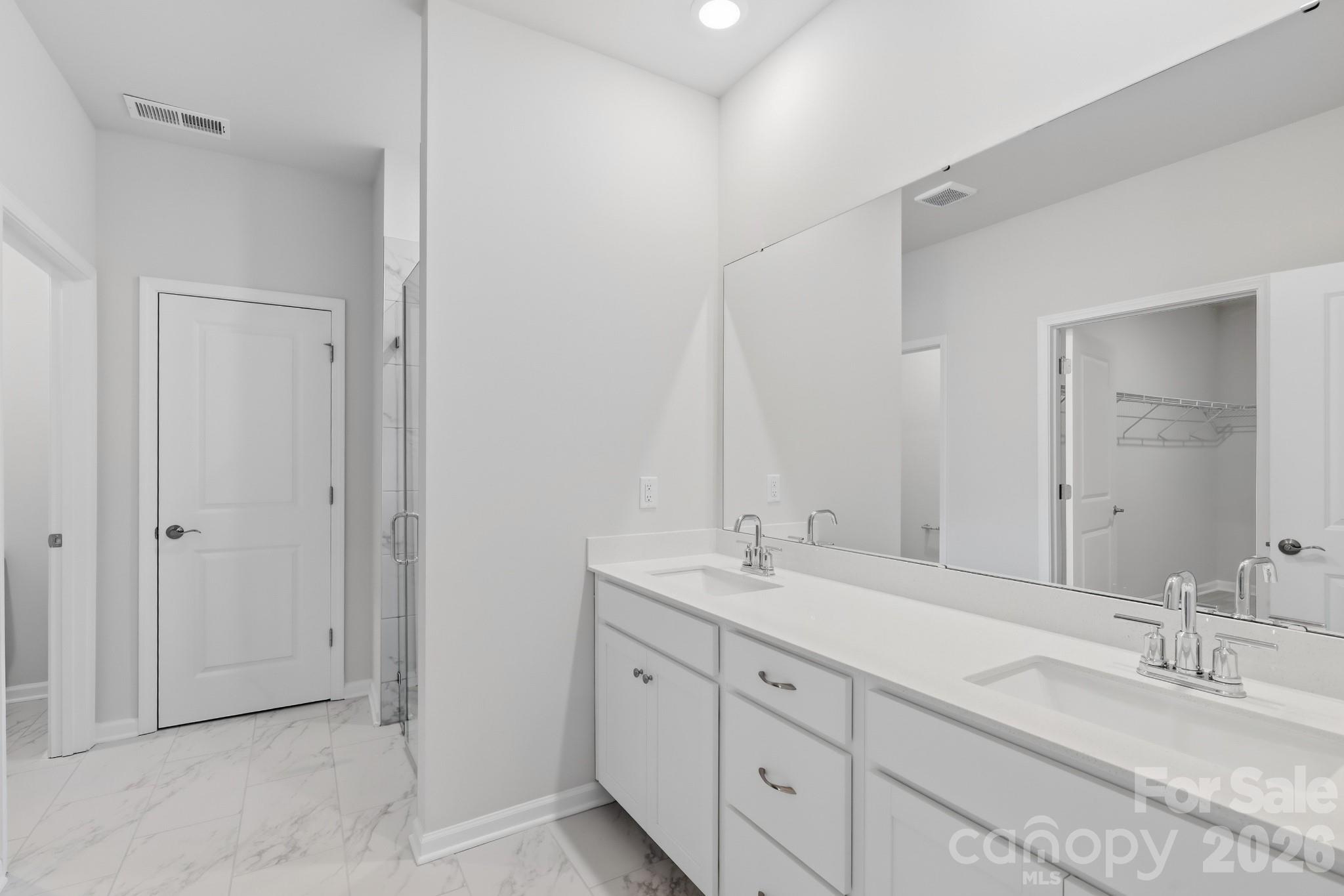 5450 Redbud Road, Unit 66 Lancaster, SC 29720 - Photo 27 of 35 a bathroom with double sink and a mirror