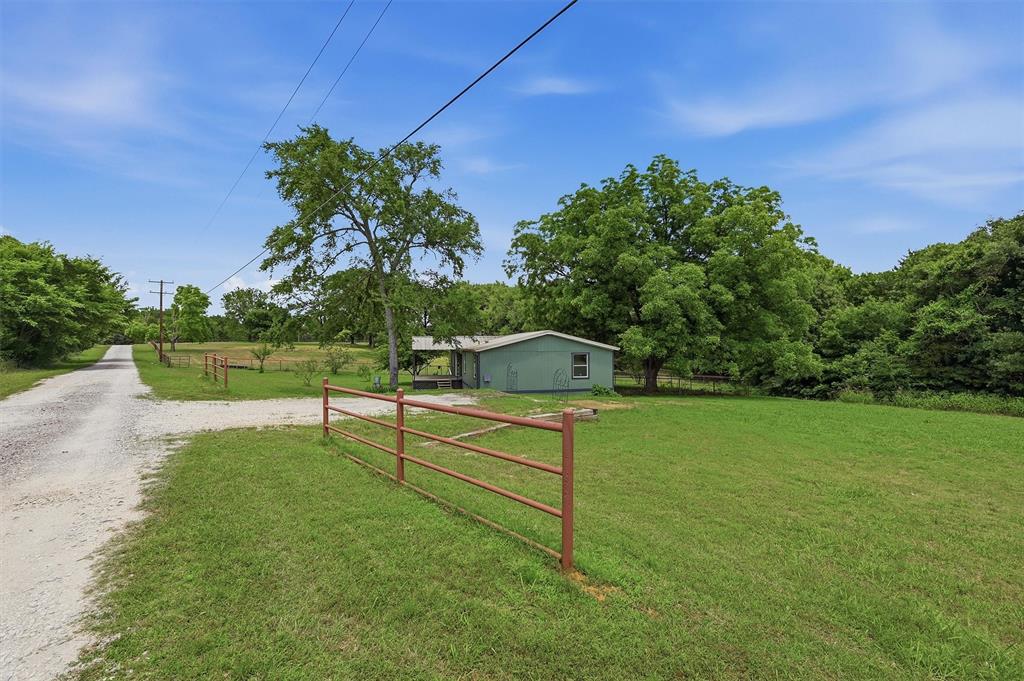 150 Gilbreath Road Sadler, TX 76264 - Photo 4 of 34 a view of a garden with a bench in the background