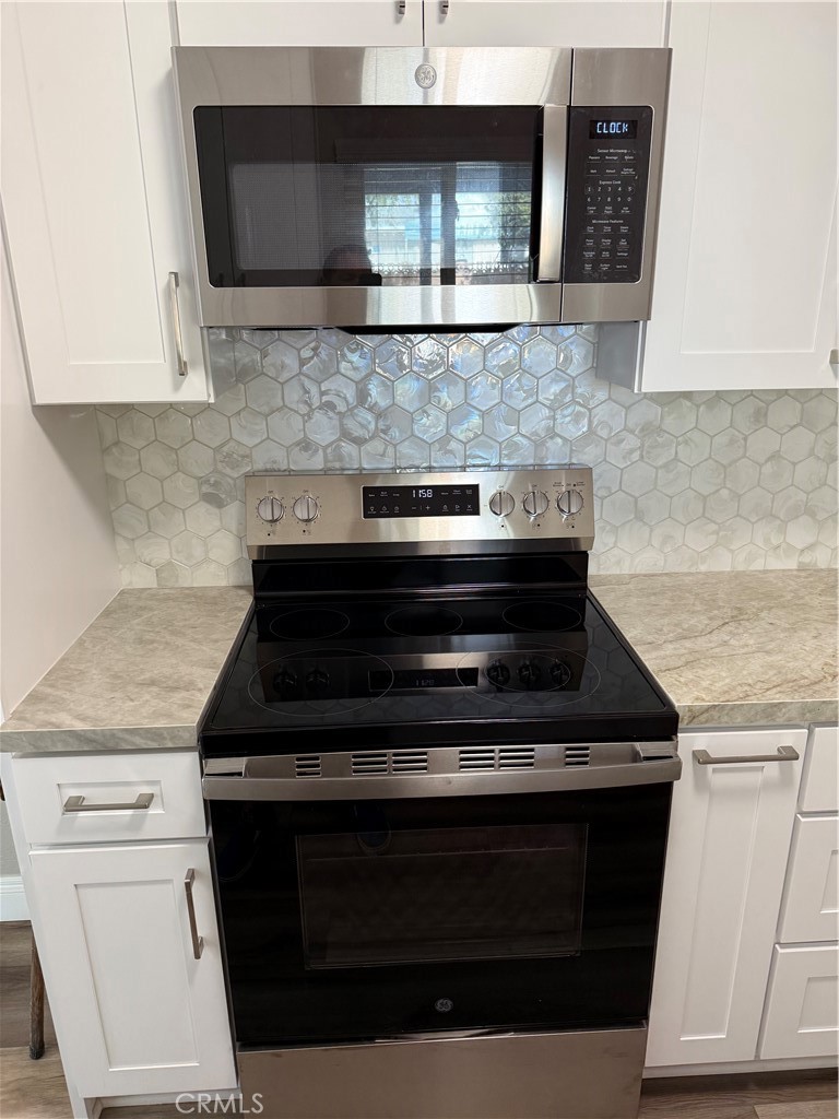 596 Opal Avenue Hemet, CA 92543 - Photo 11 of 30 a stove top oven sitting inside of a kitchen