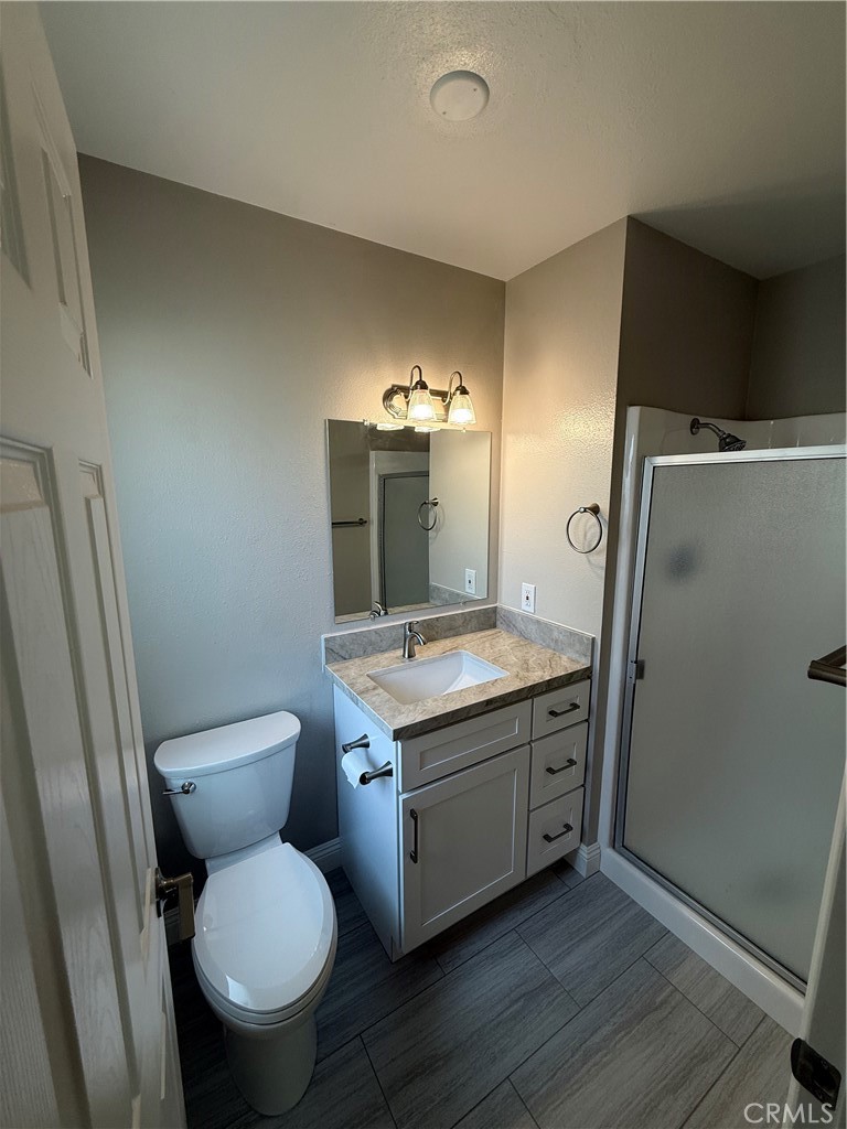 596 Opal Avenue Hemet, CA 92543 - Photo 15 of 30 a bathroom with a granite countertop toilet and a sink