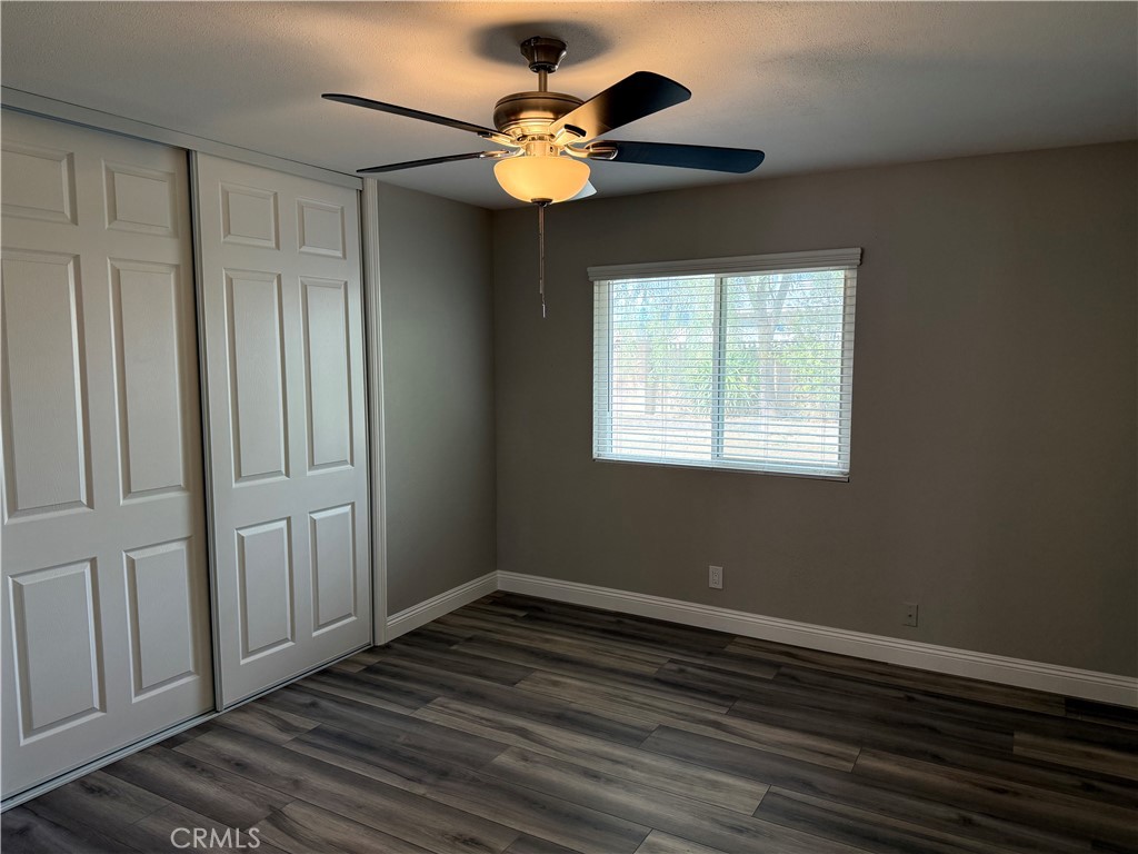 596 Opal Avenue Hemet, CA 92543 - Photo 17 of 30 a view of an empty room with wooden floor and a window