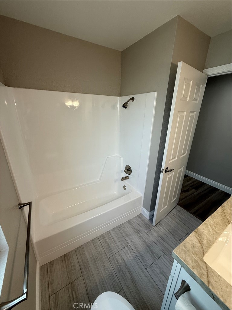 596 Opal Avenue Hemet, CA 92543 - Photo 18 of 30 a bathroom with a bathtub a sink and a toilet