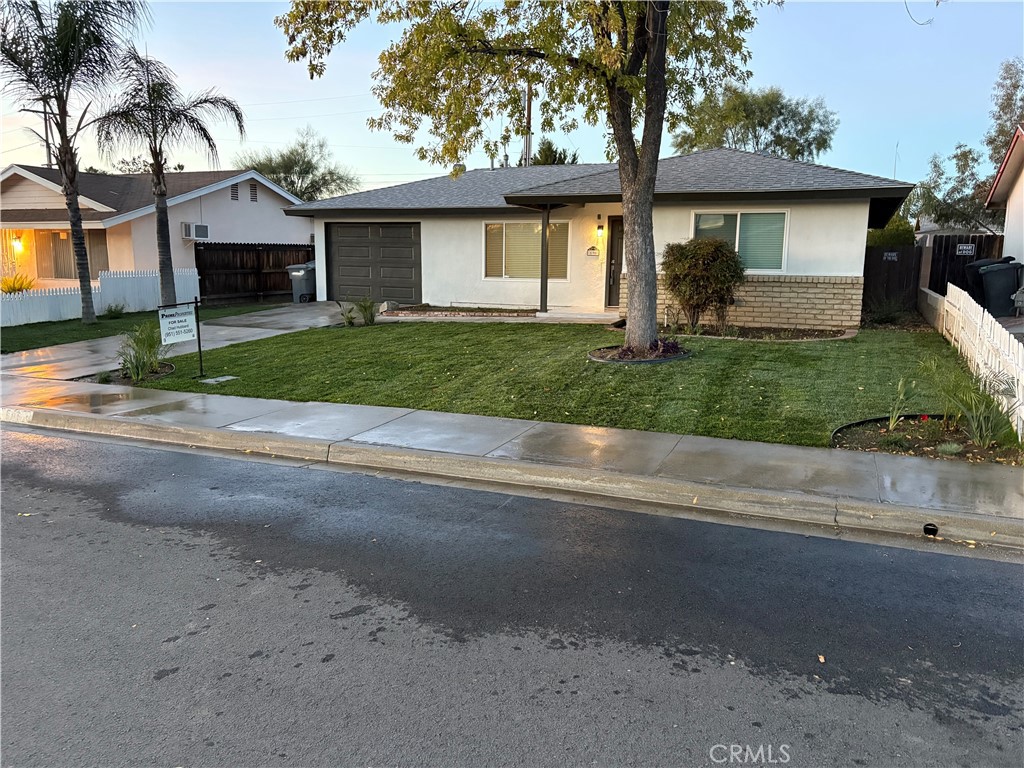 596 Opal Avenue Hemet, CA 92543 - Photo 2 of 30 a front view of a house with a yard and garage
