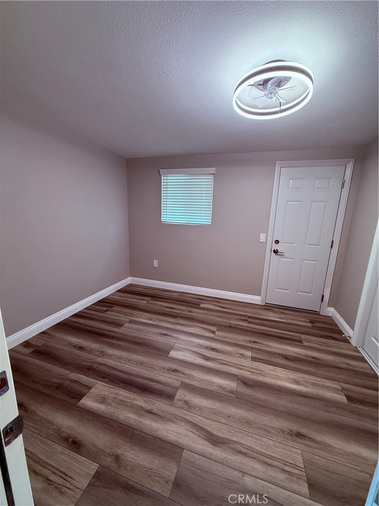 596 Opal Avenue Hemet, CA 92543 - Photo 21 of 30 a view of a room with wooden floor and white walls