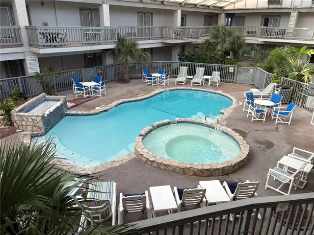 a view of a swimming pool with outdoor seating