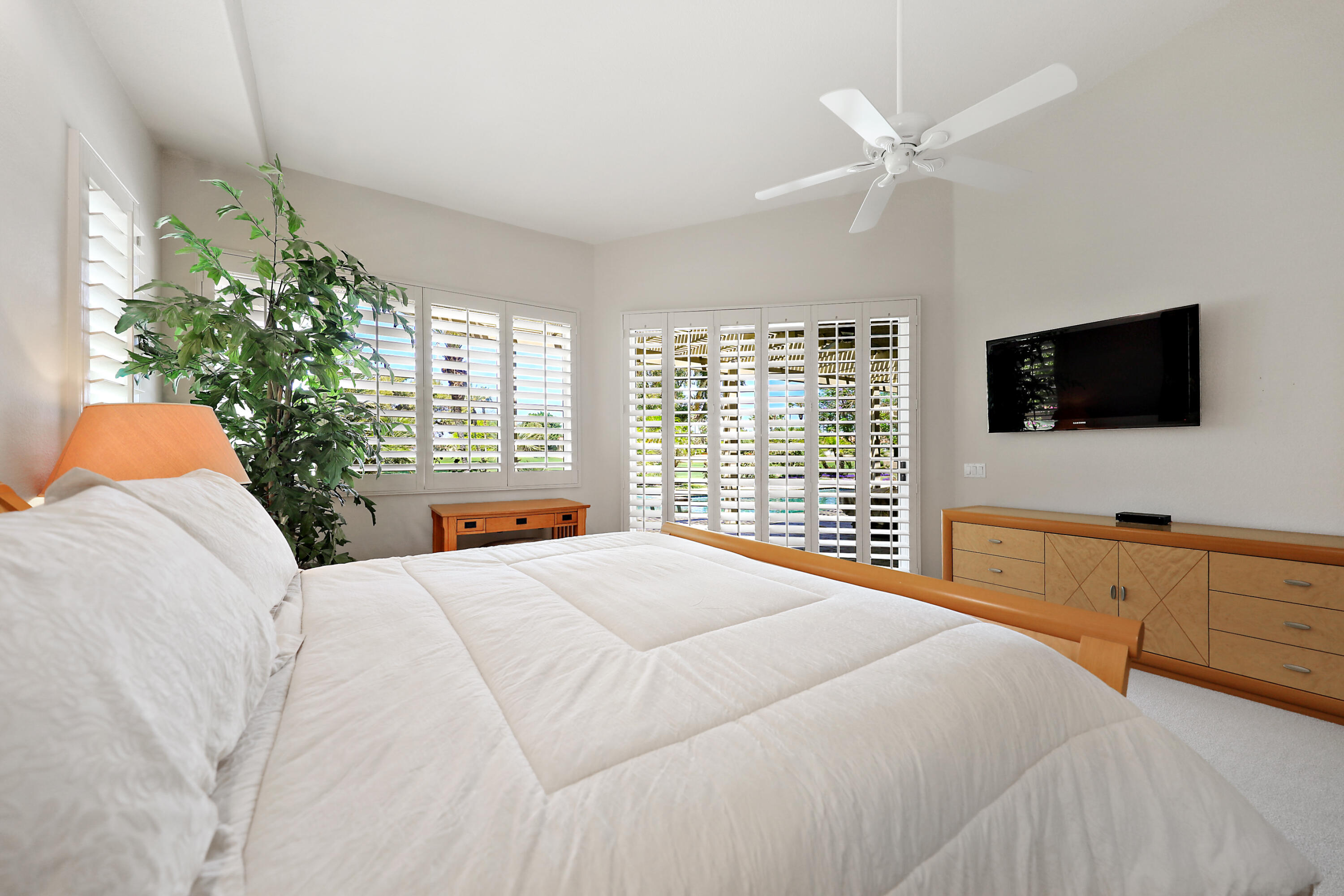43651 Port Maria Road Bermuda Dunes, CA 92203 - Photo 17 of 46 a bedroom with a bed a flat screen tv and a chandelier