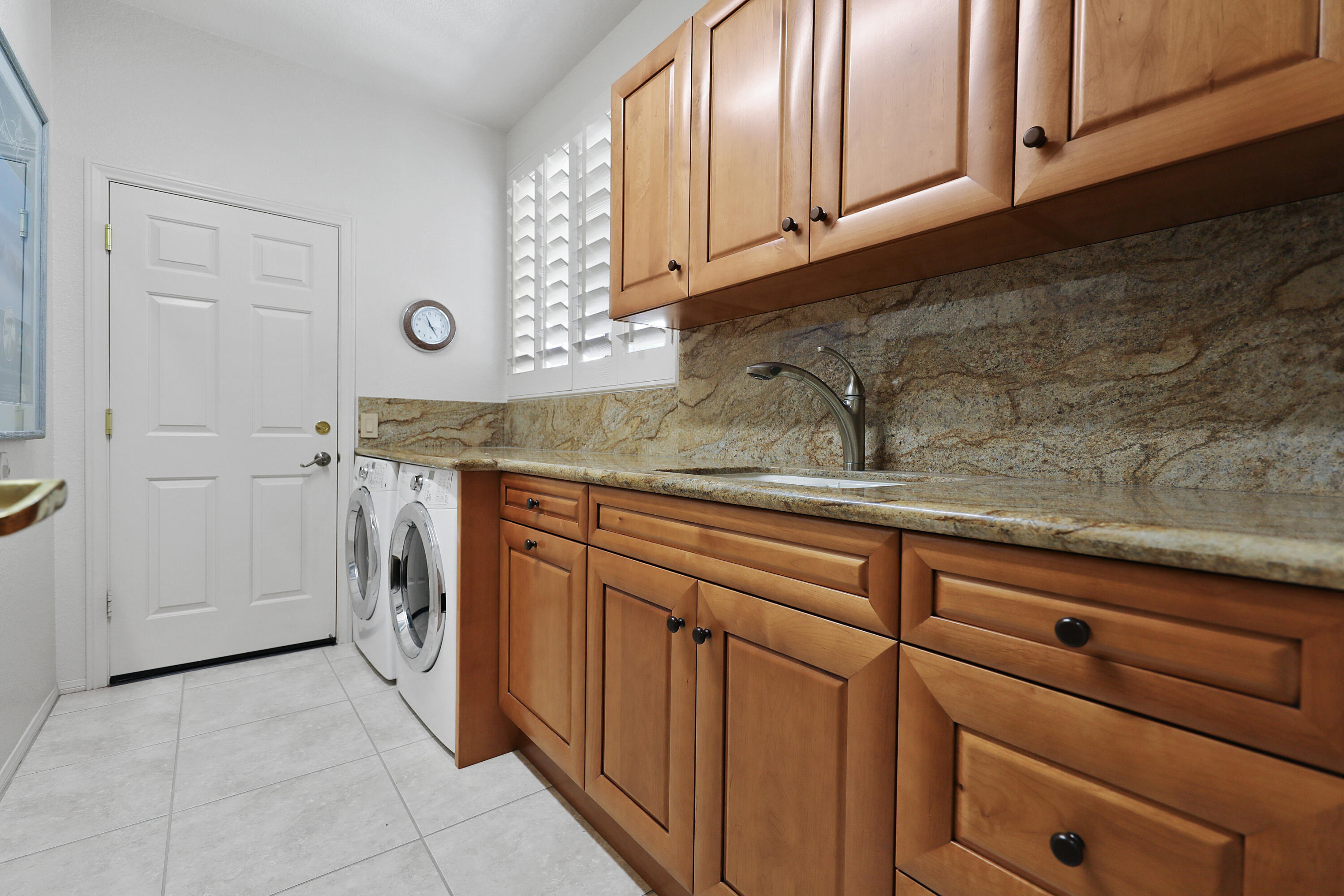 43651 Port Maria Road Bermuda Dunes, CA 92203 - Photo 25 of 46 a kitchen with stainless steel appliances granite countertop a sink and dishwasher with white cabinets