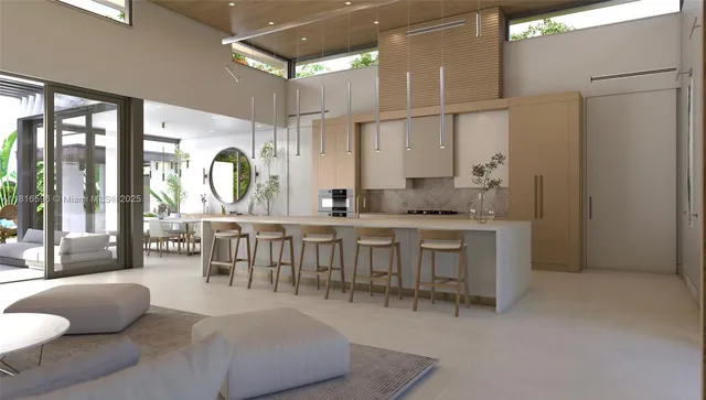 a living room with furniture a large window and stainless steel appliances