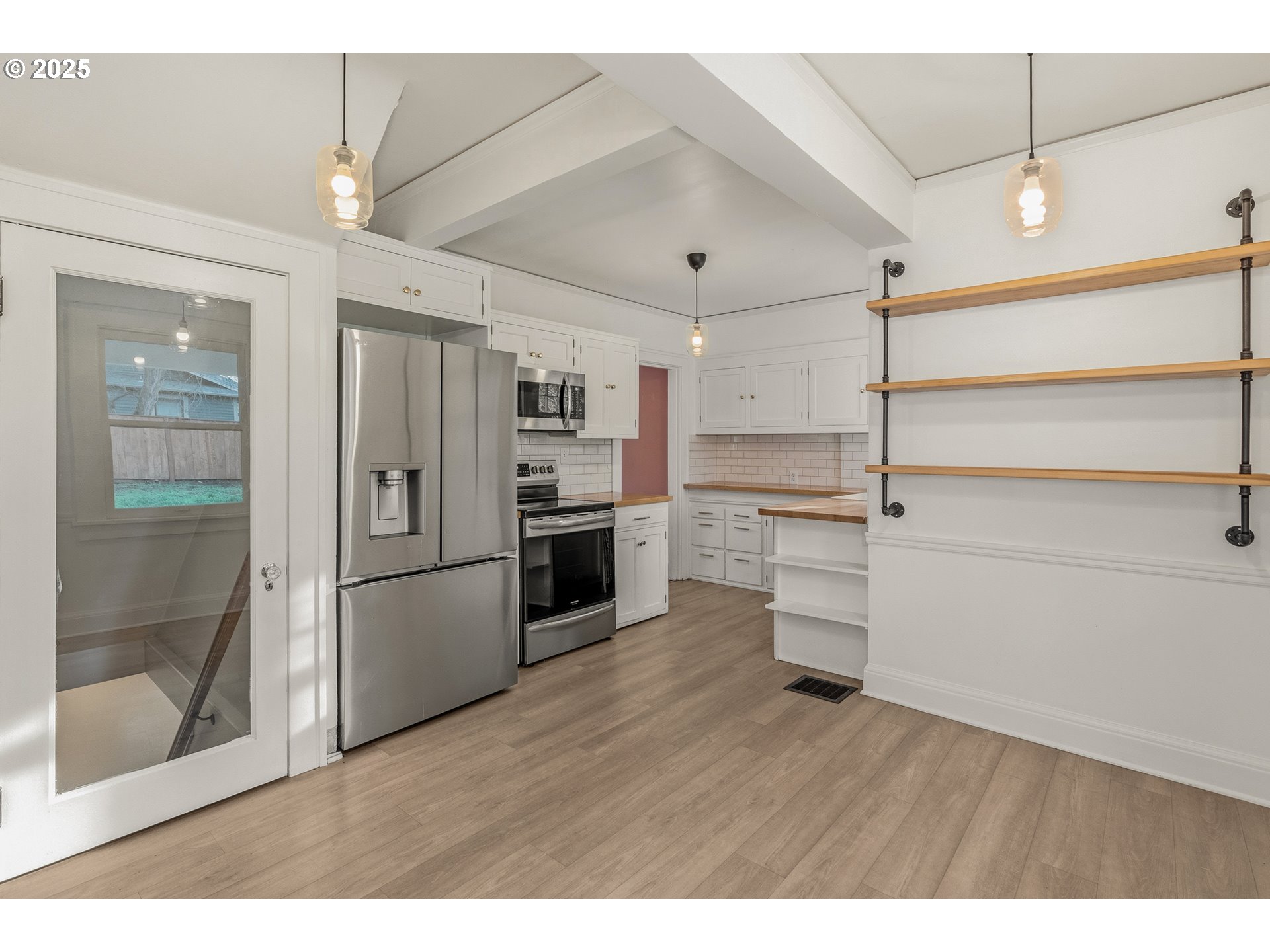 1825 Northeast 53rd Avenue Portland, OR 97213 - Photo 17 of 41 a kitchen with a refrigerator and a wooden floor