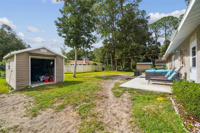 a view of a house with swimming pool and sitting area