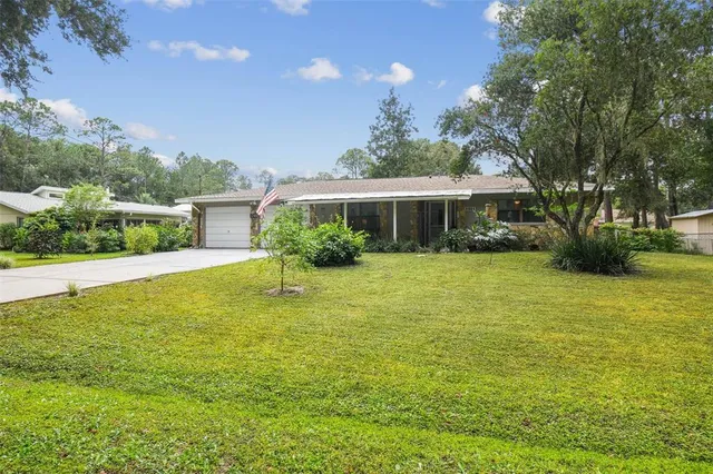 a view of house with garden space and trees