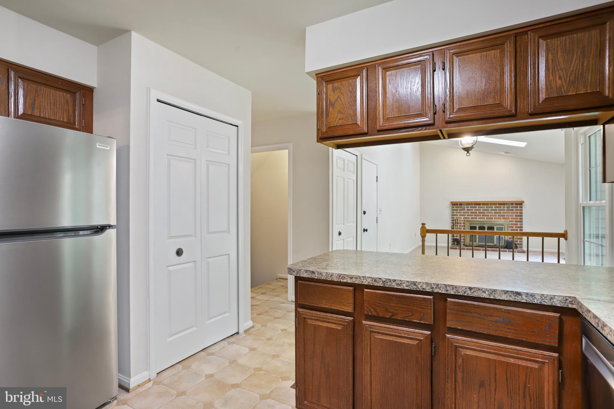 15108 Plum Tree Way Bowie, MD 20721 - Photo 12 of 51 a kitchen with granite countertop cabinets and refrigerator