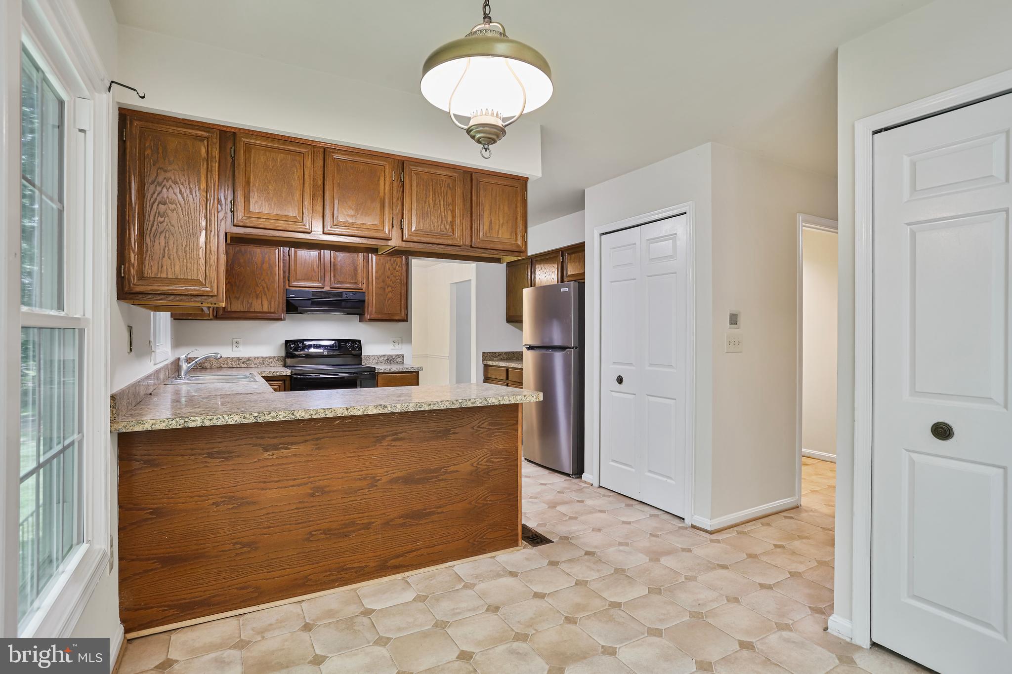 15108 Plum Tree Way Bowie, MD 20721 - Photo 14 of 51 a kitchen with stainless steel appliances granite countertop a refrigerator a stove and a sink with granite countertops