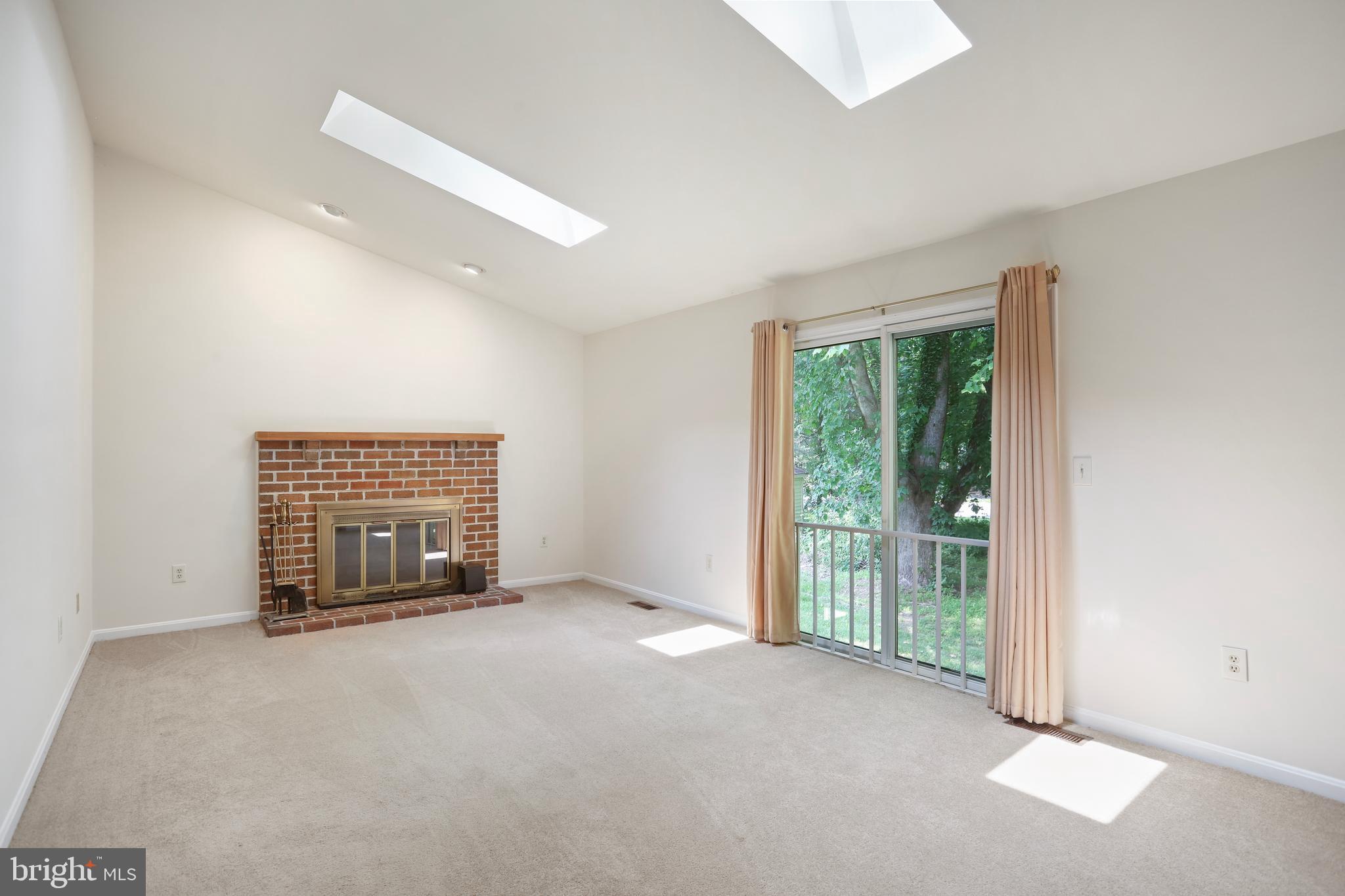 15108 Plum Tree Way Bowie, MD 20721 - Photo 18 of 51 an empty room with floor to ceiling windows and fireplace