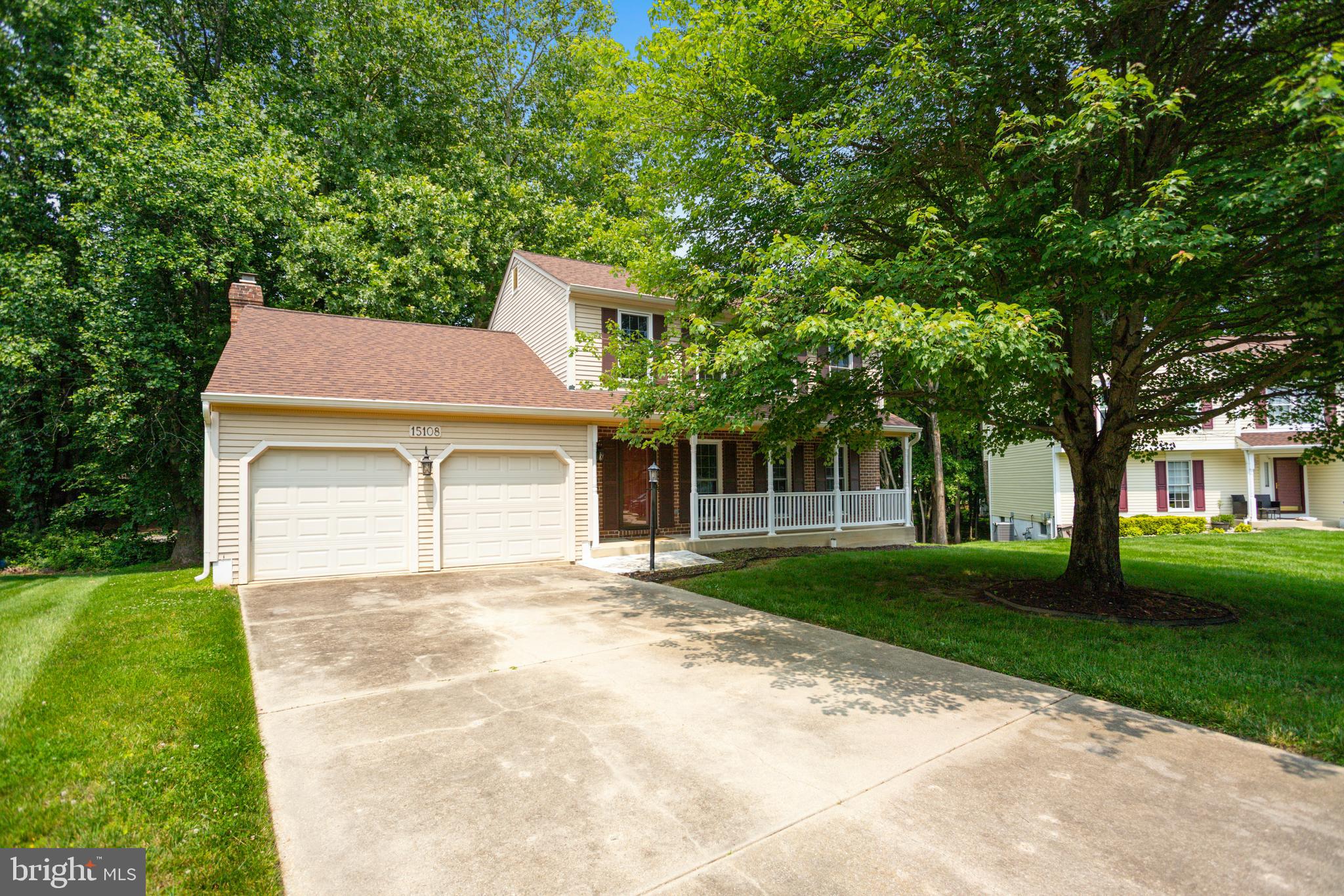 15108 Plum Tree Way Bowie, MD 20721 - Photo 2 of 51 a front view of a house with a garden and trees