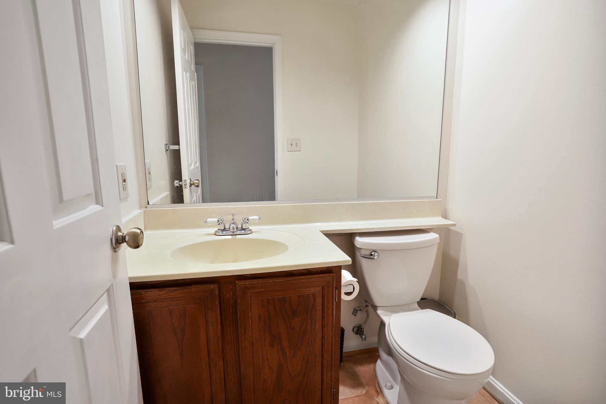 15108 Plum Tree Way Bowie, MD 20721 - Photo 29 of 51 a bathroom with a toilet a sink and a mirror