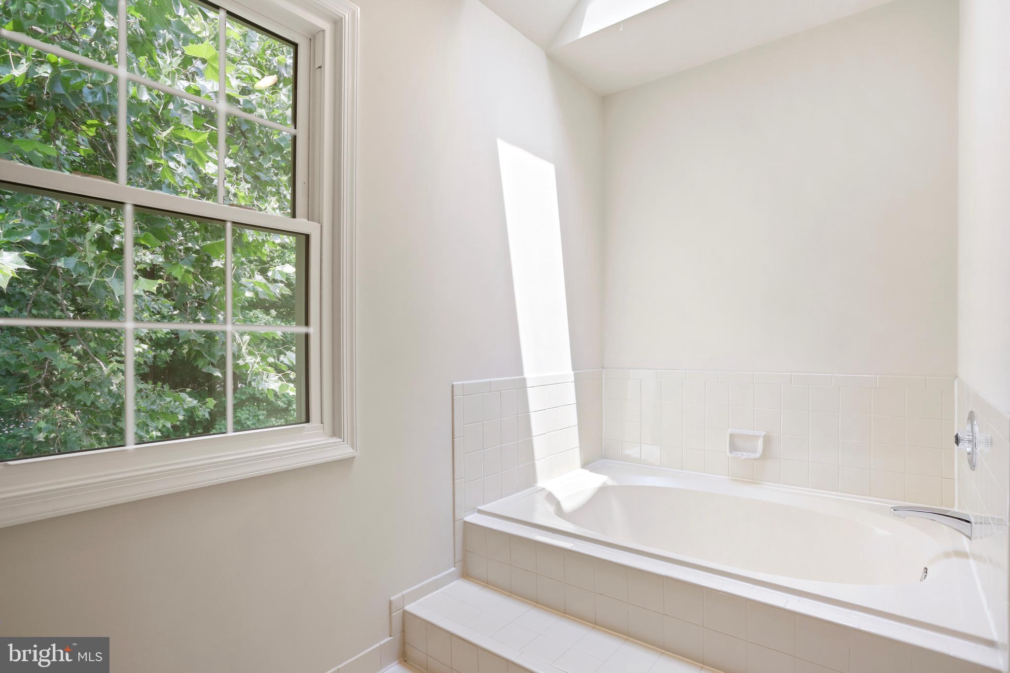 15108 Plum Tree Way Bowie, MD 20721 - Photo 37 of 51 a bathroom with a bathtub and window
