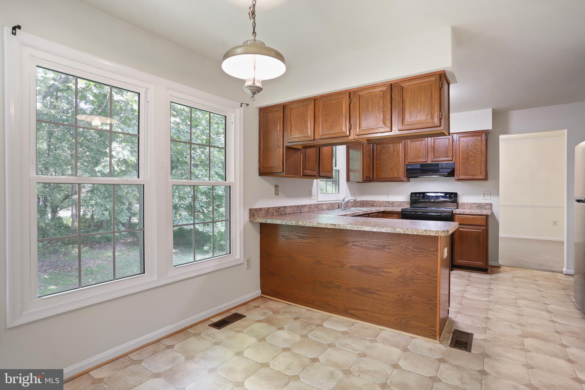15108 Plum Tree Way Bowie, MD 20721 - Photo 10 of 51 a kitchen with granite countertop a stove cabinets and refrigerator